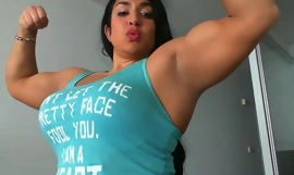 Spunky naispuolinen kehonrakentaja ylpeänä näyttää lihaksensa